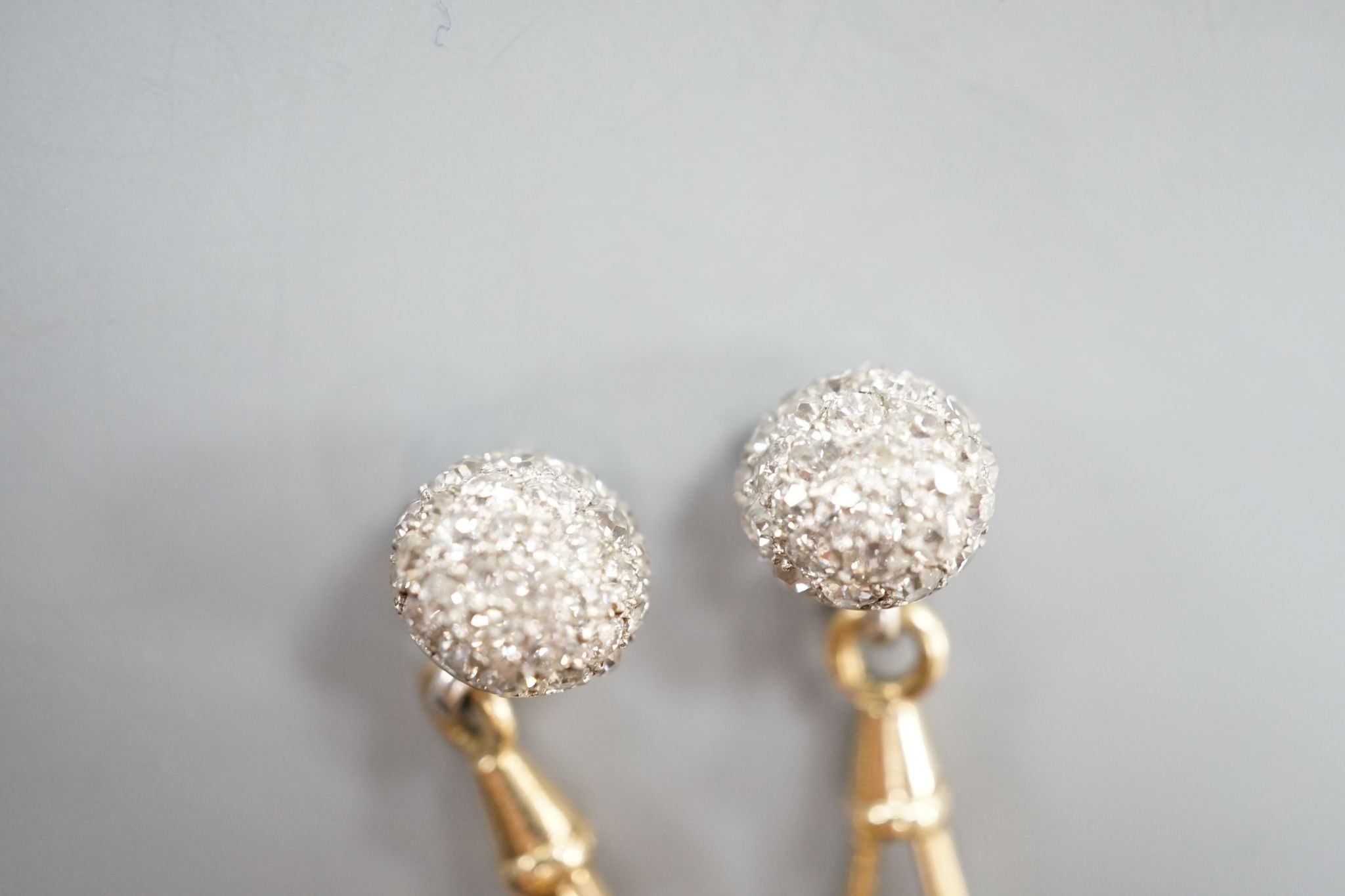 A pair of yellow metal and pave set ruby and diamond cufflinks (adapted), gross weight 10 grams.